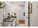Bathroom featuring a granite countertop vanity, mirror, and neutral wall paint at 336 Painted Horse Way, Erie, CO 80516