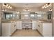 Luxurious bathroom featuring a double vanity, granite countertops, ample lighting, and a makeup vanity at 336 Painted Horse Way, Erie, CO 80516