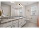 Bright bathroom featuring double sinks, granite countertop, and tiled floor at 336 Painted Horse Way, Erie, CO 80516