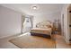 Cozy bedroom featuring a jute rug, king bed, and natural light from the window at 336 Painted Horse Way, Erie, CO 80516