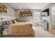 Comfortable bedroom with built-in shelving, carpet, and natural light from a large window at 336 Painted Horse Way, Erie, CO 80516