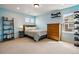 Cozy bedroom with light blue walls, carpet, and a large window providing natural light at 336 Painted Horse Way, Erie, CO 80516