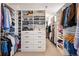 Walk-in closet with custom shelving and drawers for organized storage at 336 Painted Horse Way, Erie, CO 80516