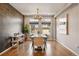 Elegant dining room with hardwood floors, wood accent wall, and contemporary chandelier lighting at 336 Painted Horse Way, Erie, CO 80516