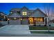 Charming two-story home with a three-car garage, stone accents, and a landscaped front yard at 336 Painted Horse Way, Erie, CO 80516