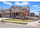 Charming home features a red stucco exterior, gray accents and well-maintained yard at 336 Painted Horse Way, Erie, CO 80516