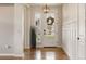 Welcoming foyer with hardwood floors, a decorative light fixture, and a view of the front yard at 336 Painted Horse Way, Erie, CO 80516