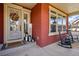 Inviting front porch decorated with a wreath, lanterns, and rocking chairs at 336 Painted Horse Way, Erie, CO 80516