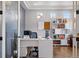 Bright home office featuring a modern white desk, herringbone accent wall, and stylish shelving at 336 Painted Horse Way, Erie, CO 80516