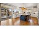 Bright, modern kitchen with stainless appliances, a large island with bar stools, and a sliding patio door at 336 Painted Horse Way, Erie, CO 80516