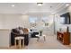 Comfortable living area with a large sofa, modern decor, and ample natural light, ideal for relaxing and entertaining at 336 Painted Horse Way, Erie, CO 80516