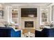 Cozy living room with a stone fireplace, recessed lighting, and comfortable seating at 336 Painted Horse Way, Erie, CO 80516