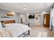 Spacious primary bedroom featuring a large bed, dresser, and a view into a separate office and bathroom at 336 Painted Horse Way, Erie, CO 80516