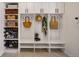 Well-organized mudroom with white cabinets, shelving, and storage baskets for convenient entryway organization at 336 Painted Horse Way, Erie, CO 80516