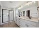Beautiful bathroom features a double sink vanity with black hardware and a glass enclosed shower at 1318 Sienna Peak Cir, Erie, CO 80516