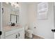 Well-lit bathroom with a white vanity, dark hardware, and a tiled walk-in shower at 1318 Sienna Peak Cir, Erie, CO 80516