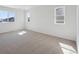 Carpeted bedroom with windows providing natural light at 1318 Sienna Peak Cir, Erie, CO 80516