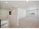 Spacious bonus room with neutral carpet, large windows, and plenty of natural light at 1318 Sienna Peak Cir, Erie, CO 80516