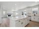 Bright and airy kitchen with an island, stainless steel appliances, and an open floor plan at 1318 Sienna Peak Cir, Erie, CO 80516