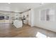 Open-concept kitchen with white cabinets, stainless steel appliances, and a large island with quartz countertops at 1318 Sienna Peak Cir, Erie, CO 80516