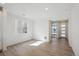 Bright living room with modern wood floors, neutral walls, and natural light from a large window at 1318 Sienna Peak Cir, Erie, CO 80516