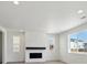 Cozy living room with a fireplace, natural light, and modern flooring, perfect for relaxing at 1318 Sienna Peak Cir, Erie, CO 80516