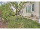 Lush backyard features mature trees, green grass, and stone pathways for a peaceful retreat at 17484 E 99Th Ave, Commerce City, CO 80022