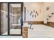 Bathroom with a walk-in shower, soaking tub and unique decor at 17484 E 99Th Ave, Commerce City, CO 80022