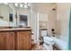 Well-maintained bathroom with a tub, shower, and a wood vanity at 17484 E 99Th Ave, Commerce City, CO 80022
