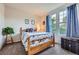 Bedroom with two windows, plush carpet and bright blue curtains at 17484 E 99Th Ave, Commerce City, CO 80022