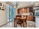 A dining area with sliding glass doors opens up the kitchen with custom cabinets and granite countertops at 17484 E 99Th Ave, Commerce City, CO 80022