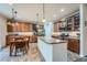 Spacious kitchen with stainless steel appliances, granite countertops, a kitchen island, and ample storage cabinets at 17484 E 99Th Ave, Commerce City, CO 80022