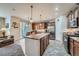 Lovely kitchen featuring an island, granite countertops, stainless appliances, and a dining area with sliding glass doors at 17484 E 99Th Ave, Commerce City, CO 80022