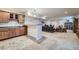 Open basement area featuring a kitchenette, Gathering room area, and tile and carpet flooring at 17484 E 99Th Ave, Commerce City, CO 80022
