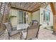 Outdoor patio space with a covered pergola, brick pavers, table, and a sliding glass door at 17484 E 99Th Ave, Commerce City, CO 80022