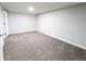 Finished basement with neutral carpet and baseboards, light walls and door at 3061 W 92Nd Ave # 2D, Westminster, CO 80031