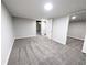 Finished basement with neutral carpet, light walls and baseboards with access to unfinished storage space at 3061 W 92Nd Ave # 2D, Westminster, CO 80031
