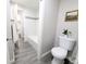 Neutral bathroom featuring gray flooring, a toilet, a tiled shower with glass door, and wall decor at 3061 W 92Nd Ave # 2D, Westminster, CO 80031
