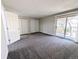 Bright bedroom with gray carpet, sliding glass door and two closets at 3061 W 92Nd Ave # 2D, Westminster, CO 80031