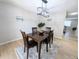 Cozy dining room features wood table with seating for four and a modern overhead light fixture at 3061 W 92Nd Ave # 2D, Westminster, CO 80031