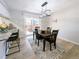 Bright dining area features modern light fixture and sliding glass doors to the outdoor living space at 3061 W 92Nd Ave # 2D, Westminster, CO 80031