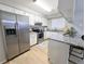 Modern kitchen features stainless steel refrigerator and granite countertops with breakfast bar at 3061 W 92Nd Ave # 2D, Westminster, CO 80031