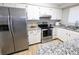 Modern kitchen features stainless steel appliances and white cabinets at 3061 W 92Nd Ave # 2D, Westminster, CO 80031