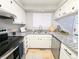 Well-lit kitchen featuring granite countertops, stainless steel appliances and modern fixtures at 3061 W 92Nd Ave # 2D, Westminster, CO 80031