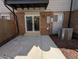 Back patio with brick exterior and sliding door leading to backyard at 3061 W 92Nd Ave # 2D, Westminster, CO 80031