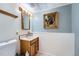 Bathroom with a wood vanity, decorative framed art, and tiled floors at 16147 E Bethany Pl, Aurora, CO 80013