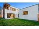 Modern home with large windows and backyard with green lawn and privacy fence at 1601 S Columbine St, Denver, CO 80210