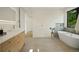 Elegant bathroom boasting a freestanding tub, stylish vanity, and a bright window for natural light at 1601 S Columbine St, Denver, CO 80210