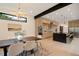 Open concept dining area leads to the kitchen with stainless appliances and black marble island at 1601 S Columbine St, Denver, CO 80210