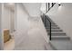 Spacious hallway features carpeting and staircase with black metal railings at 1601 S Columbine St, Denver, CO 80210